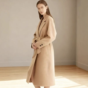 Elegant long camel wool coat with classic lapels and matching waist belt for women