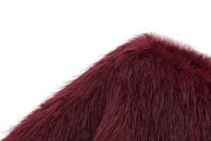 Detailed macro view of plush wine red faux fur texture showing dense glossy fibers