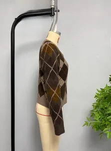 Detail of diamond pattern knitwear with ribbed cuffs in brown and khaki tones