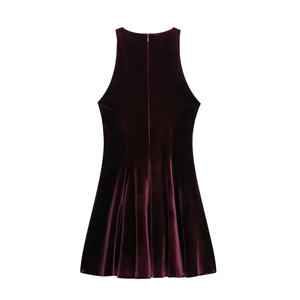 Detail of burgundy velvet sleeveless dress showing the back hidden zipper and pleated hemline