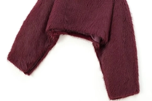 Detail of burgundy faux fur texture with smooth satin lining on short coat hem