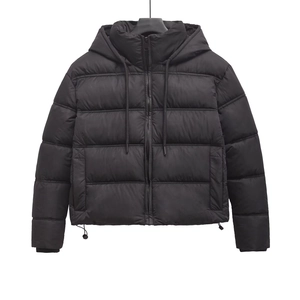 Women's black hooded puffer jacket with street style quilted design and adjustable drawstrings
