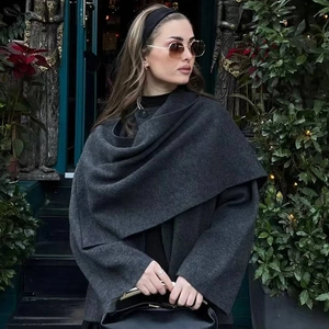 Women's dark grey knitted coat featuring an asymmetrical scarf collar and chic cape style