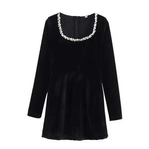 Close-up of square neckline featuring hand-sewn marquise rhinestones on velvet dress