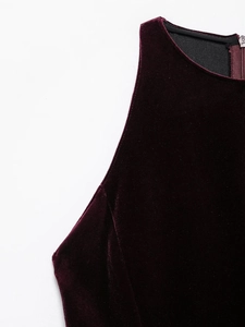 Close-up of the smooth burgundy velvet fabric and invisible back zipper on the dress