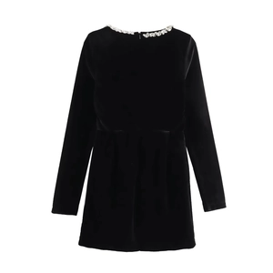 Detail of square neckline with silver rhinestones on luxury black velvet dress