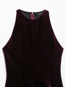 Close-up of a burgundy velvet sleeveless dress with high neck and back zipper detail