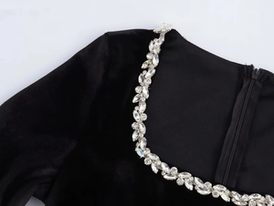 Close-up of square neck velvet dress with marquise cut rhinestone chain and hidden zipper