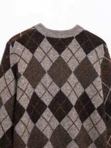 Detailed close-up of diamond pattern knit texture and soft mohair blend fabric fibers