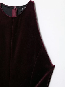 Detailed close-up of velvet sleeveless dress featuring a back zipper and a high neckline