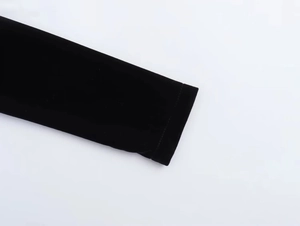 Detailed close-up of square neck velvet dress cuffs with premium texture and stitching