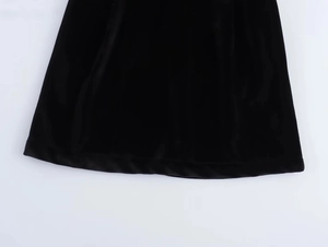 Macro shot of high-quality black velvet fabric showing smooth texture and fine stitching