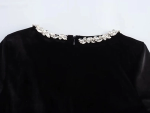 Close-up of velvet dress square neckline with crystal rhinestones and hidden zipper