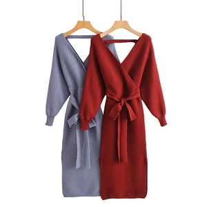 Detail of V-neck knit midi dress with waist tie and side slit in red and blue colors