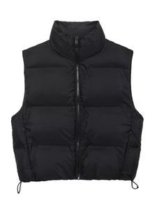 Detail of black puffer vest with stand collar, metal zipper, and adjustable hem drawstrings