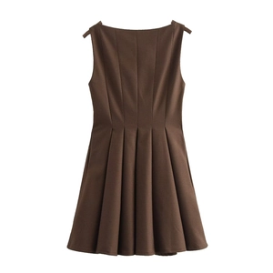 Detail view of brown sleeveless plaid dress showing waist pleats and fine textured fabric