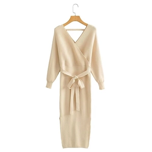 Detail of V-neck wrap design and ribbed texture on apricot knit midi dress with belt