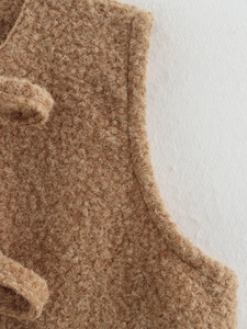 Close-up detail of the premium caramel brown fuzzy wool vest with textured fleece fabric