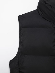 Close-up of stand-up collar and horizontal quilting on black padded vest for women
