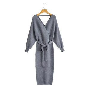 Detail view of grey knit dress featuring elegant V-neck and adjustable waist tie belt
