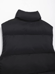 Detail view of the stand collar and horizontal quilting on a black padded vest