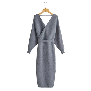 Detail of grey ribbed knit dress featuring a V-neck wrap design and matching waist belt