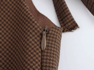 Macro detail of high-quality brown houndstooth fabric with seamless invisible zipper