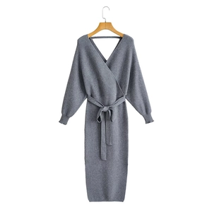 Gray knitted long sleeve V-neck midi dress with waist tie and ribbed cuffs on white backdrop
