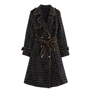 Detail of black grid long trench coat with gold buttons and a belted waist design