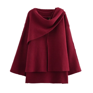 Detail view of burgundy knit coat with integrated scarf and elegant button closure