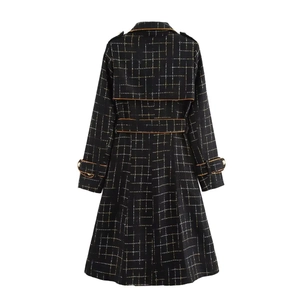 Detail view of black plaid tweed coat back with stylish brown contrast piping and belted waist