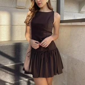 Elegant sleeveless dark brown mini dress with round neck and pleated ruffle hem details