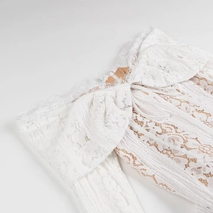 Elegant white lace off-shoulder dress with layered ruffles and front tie detailing