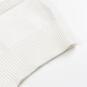 Close-up of white ribbed knit fabric texture showing high-quality elastic weave detail
