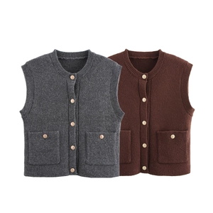 Detail of knit vests featuring metallic buttons and front patch pockets in two colors