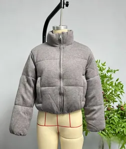 Detailed front view of a grey knitted puffer jacket with stand collar on a mannequin