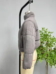 Detail view of the stand-up collar and side profile of this gray quilted jacket