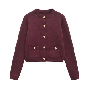 Detail of burgundy knit cardigan with premium gold buttons and flap pockets texture