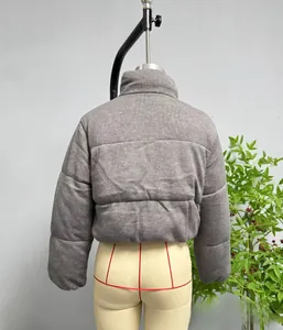 Rear view detail of grey quilted puffer jacket featuring a stand collar and knitted texture