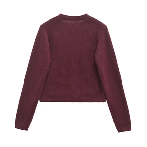 Macro view of burgundy long-sleeve knit cardigan back with ribbed cuffs and hem details