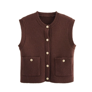 Detail of dark brown knit vest with gold buttons and front pockets in vintage style