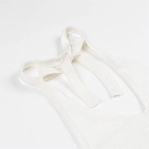 Ivory white sleeveless halter neck knit crop top featuring elegant shoulder tie details