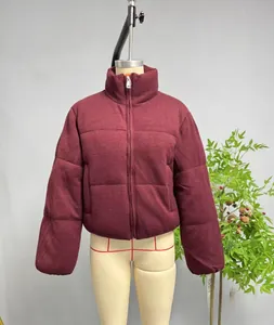 Detail of burgundy standing collar puffer jacket showing zipper and knit texture