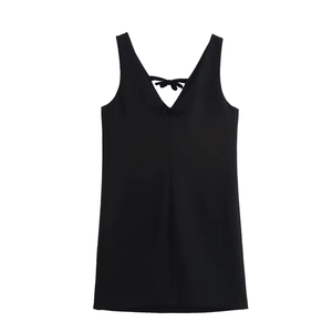Detail of a black V-neck velvet dress showing the elegant bow decoration on the back