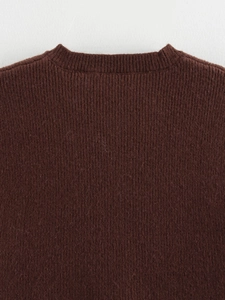 Close-up of ribbed knit texture and neckline on a dark coffee brown vest top