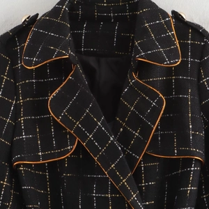 Women's black gold plaid tweed coat with orange trim and decorative gold buttons
