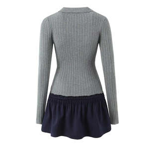 Detail of grey ribbed knit bodice spliced with navy blue ruffled hem on back of dress