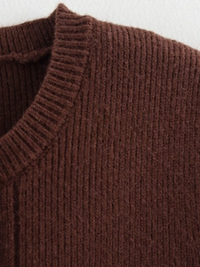 Detailed close-up of brown knit vest showing the ribbed texture and high-quality stitching