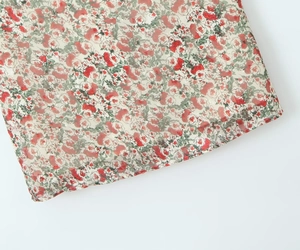 Detailed macro shot of red rose floral print on lightweight sheer chiffon fabric
