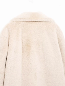 Detail shot of plush faux fur collar in cream white with soft warm texture